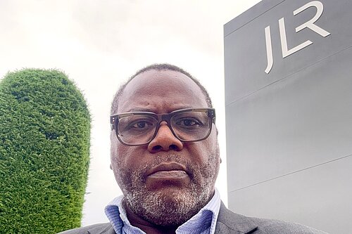 Cllr Ade Adeyemo outside JLR's Solihull Plant